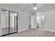 Open and airy bedroom with access to en-suite bathroom and sliding doors leading to an outdoor patio at 7360 Ulmerton Rd # 17D, Largo, FL 33771