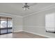 Bright bedroom with sliding glass doors leading to an outdoor patio, and modern ceiling fan at 7360 Ulmerton Rd # 17D, Largo, FL 33771