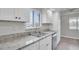Updated kitchen featuring granite countertops, a stainless sink and modern appliances at 7360 Ulmerton Rd # 17D, Largo, FL 33771
