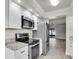 Modern kitchen featuring stainless appliances, granite countertops, and ample white cabinetry at 7360 Ulmerton Rd # 17D, Largo, FL 33771