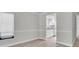 Light-filled living room with neutral walls and flooring, open to the updated kitchen at 7360 Ulmerton Rd # 17D, Largo, FL 33771