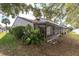 Enclosed patio with screen and lush landscaping surrounds the home at 7360 Ulmerton Rd # 17D, Largo, FL 33771