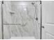 Contemporary shower featuring a glass enclosure, handheld shower head, and marble-look tile surround at 7360 Ulmerton Rd # 17D, Largo, FL 33771
