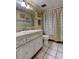 Cozy bathroom features a tile floor, vanity, and a Paris-themed shower curtain at 7425 Bay Island S Dr # 203, South Pasadena, FL 33707