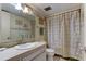 Well-lit bathroom features a vanity and a shower with unique Paris-themed curtain at 7425 Bay Island S Dr # 203, South Pasadena, FL 33707
