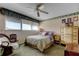 Comfortable bedroom with large window, ceiling fan, and classic furniture at 7425 Bay Island S Dr # 203, South Pasadena, FL 33707