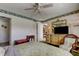 Bright bedroom featuring a large dresser, ceiling fan, and access to another room at 7425 Bay Island S Dr # 203, South Pasadena, FL 33707