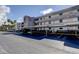 Exterior view of the building with covered parking and well-maintained landscaping at 7425 Bay Island S Dr # 203, South Pasadena, FL 33707