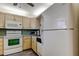 Efficient kitchen featuring white appliances, and ample cabinetry for storage at 7425 Bay Island S Dr # 203, South Pasadena, FL 33707