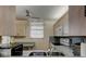 Traditional-style kitchen featuring stainless sink, appliances, countertops and ample cabinetry at 7425 Bay Island S Dr # 203, South Pasadena, FL 33707