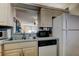 Cozy kitchen with stainless steel sink, microwave, dishwasher, and seamless access to the dining area at 7425 Bay Island S Dr # 203, South Pasadena, FL 33707