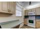 Well-lit kitchen area featuring wood cabinets, modern appliances, and ample counter space at 7425 Bay Island S Dr # 203, South Pasadena, FL 33707