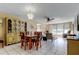 Open-concept dining and living area with tile floors, ceiling fan, and chandelier at 7425 Bay Island S Dr # 203, South Pasadena, FL 33707