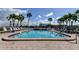 Community pool features a 4 ft depth with lounge chairs and palm trees against a sunny sky at 7425 Bay Island S Dr # 203, South Pasadena, FL 33707
