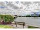 Scenic waterfront view with a bench overlooking the water, bridge, and buildings at 7425 Bay Island S Dr # 203, South Pasadena, FL 33707