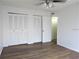 Bedroom with wood-look floors and closet space at 7526 Needle Leaf Pl # 29, Tampa, FL 33617