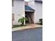 Exterior view of the building featuring light stucco and an entrance staircase at 7526 Needle Leaf Pl # 29, Tampa, FL 33617