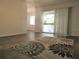 Living room with wood-look flooring, a balcony, and neutral walls at 7526 Needle Leaf Pl # 29, Tampa, FL 33617