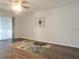 Living room featuring wood-look flooring, a ceiling fan, and sliding glass doors at 7526 Needle Leaf Pl # 29, Tampa, FL 33617