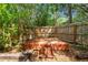 Backyard deck area nestled within a private fenced in area with a star and cross decoration on the back wall at 8309 Pebble St, Spring Hill, FL 34608