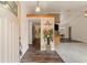 Open-concept living room featuring hardwood floors and a seamless transition into the dining and kitchen areas at 8309 Pebble St, Spring Hill, FL 34608