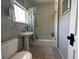 Clean bathroom with a pedestal sink, classic fixtures, and a shower-tub combination at 943 7Th N St, St Petersburg, FL 33701