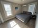 Bedroom with hardwood floors, two windows, and a ceiling fan at 943 7Th N St, St Petersburg, FL 33701