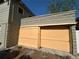 Detached garage with yellow wooden doors and unique stone block exterior at 943 7Th N St, St Petersburg, FL 33701