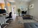 Bright living room with a workspace area and decorative rug for added comfort at 943 7Th N St, St Petersburg, FL 33701
