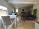 Cozy living area features wood-look tile floors, a dining table, a sofa, and a desk space at 943 7Th N St, St Petersburg, FL 33701