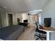 Comfortable living area with wood-look tile floors, a ceiling fan, and a workspace area at 943 7Th N St, St Petersburg, FL 33701