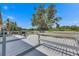 Back deck view showing grey wood, lake, and landscaping at 10048 Creek Bluff Dr, Riverview, FL 33578