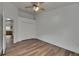 Bedroom with light wood flooring, closet, ceiling fan, and view to kitchen at 10048 Creek Bluff Dr, Riverview, FL 33578