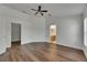 Bedroom featuring neutral walls and wood-look floors and entry to a closet and bathroom at 10048 Creek Bluff Dr, Riverview, FL 33578