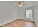 Bedroom featuring neutral walls and wood-look floors and a window at 10048 Creek Bluff Dr, Riverview, FL 33578
