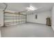 Spacious garage with epoxy floor, garage door, hot water heater, and electrical panel at 10048 Creek Bluff Dr, Riverview, FL 33578