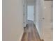 Hallway featuring wood-look floors and entry to a bathroom at 10048 Creek Bluff Dr, Riverview, FL 33578