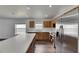 Well-lit kitchen featuring stainless steel appliances, wood cabinets, and a white countertop island at 10048 Creek Bluff Dr, Riverview, FL 33578