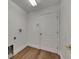 Laundry room featuring wood flooring, white door, and hookups for washer and dryer at 10048 Creek Bluff Dr, Riverview, FL 33578