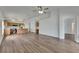 Open-concept living space with kitchen, dining, and living areas featuring wood cabinets and floors at 10048 Creek Bluff Dr, Riverview, FL 33578
