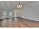 Expansive living room with wood-look floors, large windows, and a bright, airy feel at 10048 Creek Bluff Dr, Riverview, FL 33578