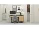 Efficient office with modern desk setup conveniently located next to laundry area at 10232 Trumpet Honeysuckle Way, San Antonio, FL 33576