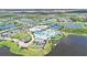 Aerial shot of community clubhouse with resort-style pool, tennis courts, and surrounding lakes at 10418 Spring Tide Way, Parrish, FL 34219