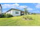 Spacious backyard featuring well-manicured lawn and a covered lanai with beautiful landscaping at 10418 Spring Tide Way, Parrish, FL 34219