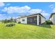 Lush backyard featuring a covered lanai, perfect for outdoor relaxation and entertainment at 10418 Spring Tide Way, Parrish, FL 34219