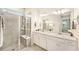 Beautiful bathroom with double sinks, glass shower, and a view to another room at 10418 Spring Tide Way, Parrish, FL 34219