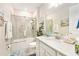 Bright bathroom featuring a shower and tub combination, and beach-themed decor at 10418 Spring Tide Way, Parrish, FL 34219