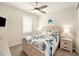 Cozy bedroom with a coastal theme, ceiling fan, and a serene atmosphere at 10418 Spring Tide Way, Parrish, FL 34219