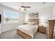Comfortable bedroom featuring a ceiling fan, bright window and warm, inviting decor at 10418 Spring Tide Way, Parrish, FL 34219