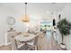 Open-concept dining area offering views of the living space and a scenic backyard at 10418 Spring Tide Way, Parrish, FL 34219